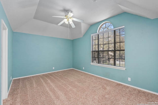 unfurnished room with lofted ceiling, carpet, baseboards, and a ceiling fan