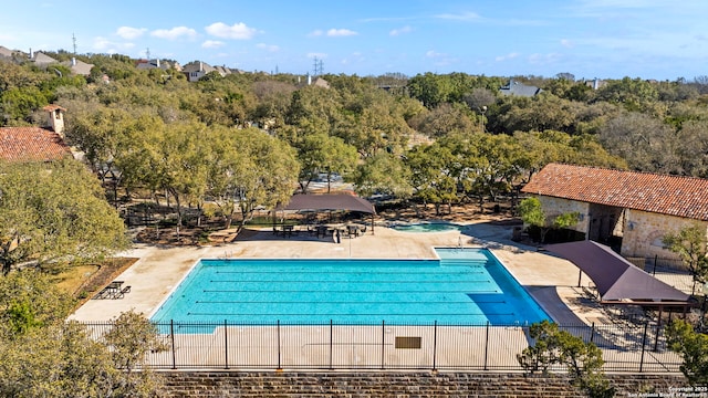 pool featuring a patio area, fence, and a gazebo