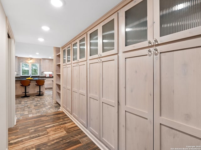 hallway with dark wood-style flooring and recessed lighting