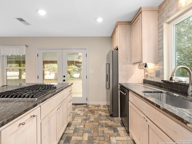 kitchen featuring visible vents, stainless steel appliances, light brown cabinetry, a sink, and recessed lighting