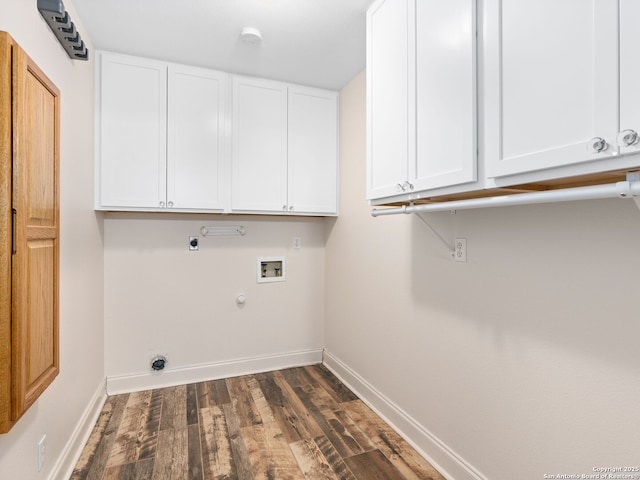 laundry room featuring cabinet space, baseboards, dark wood finished floors, hookup for a gas dryer, and electric dryer hookup