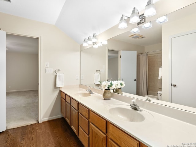 full bathroom featuring a sink, visible vents, vaulted ceiling, shower / tub combo with curtain, and double vanity