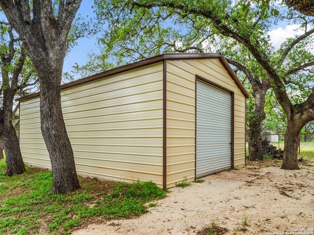 view of outbuilding with an outbuilding and fence