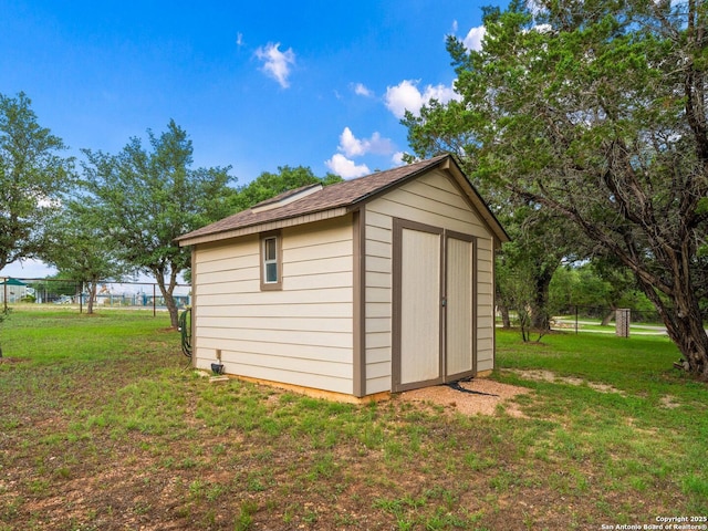 view of shed featuring fence