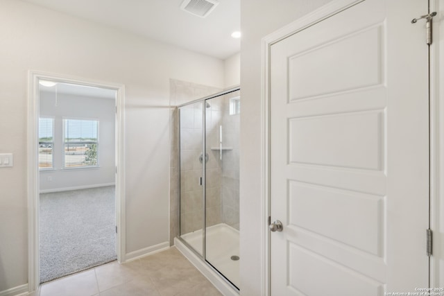 full bath with tile patterned flooring, visible vents, a shower stall, and baseboards