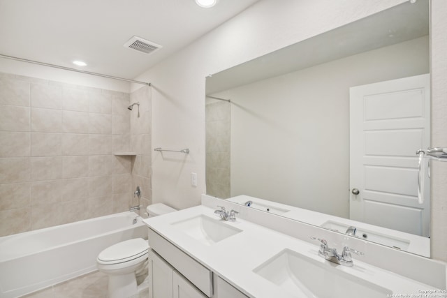 bathroom featuring toilet, shower / bathing tub combination, a sink, and visible vents