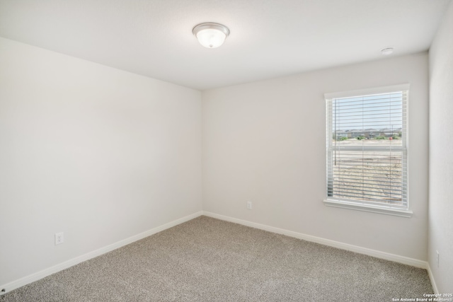 empty room with carpet and baseboards