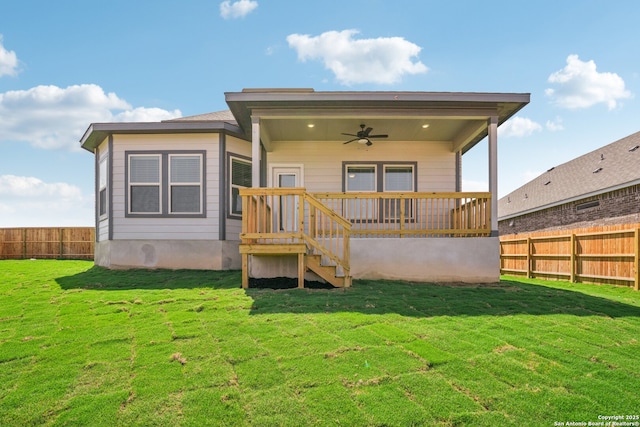 back of house featuring ceiling fan, a lawn, and a fenced backyard