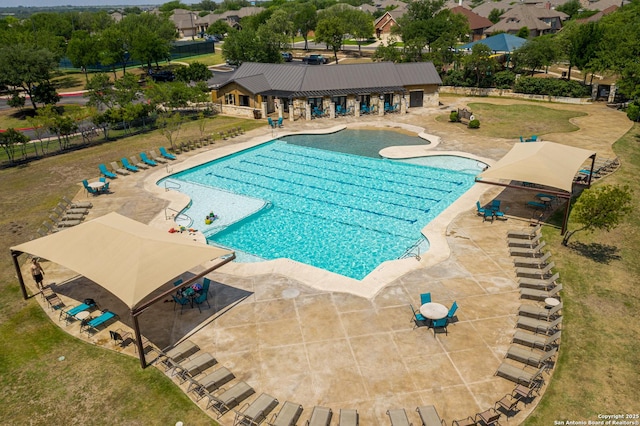 pool featuring a patio area, fence, and a yard