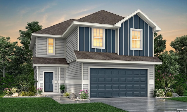 view of front of house featuring roof with shingles, driveway, and an attached garage