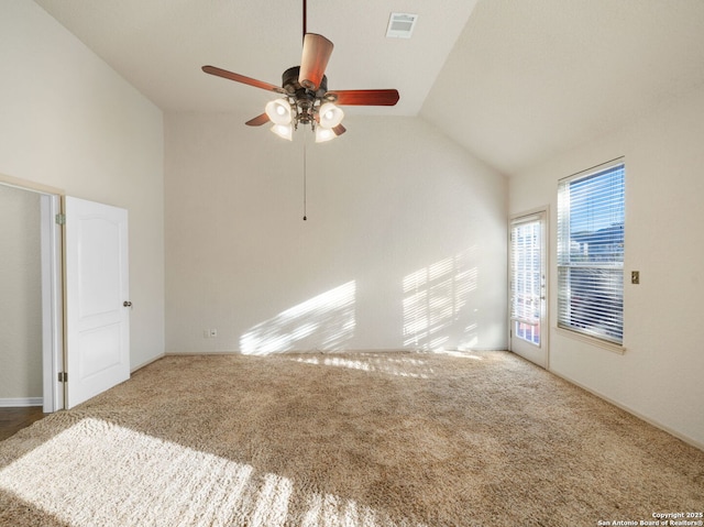 carpeted empty room featuring ceiling fan, high vaulted ceiling, and visible vents