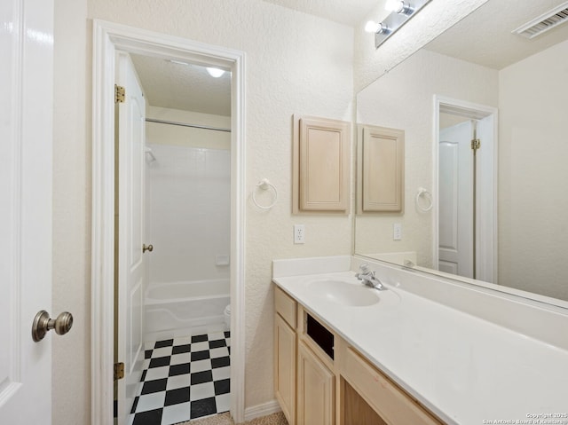 bathroom featuring visible vents, shower / tub combination, tile patterned floors, a textured ceiling, and vanity