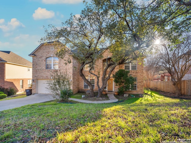 traditional home with fence, concrete driveway, and brick siding