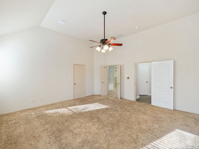 unfurnished bedroom with high vaulted ceiling, carpet flooring, visible vents, and a ceiling fan