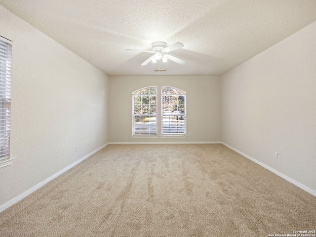 unfurnished room featuring a textured ceiling, carpet flooring, a ceiling fan, and baseboards