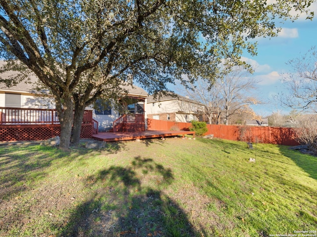 view of yard featuring fence and a wooden deck