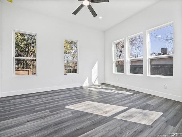 spare room with baseboards, dark wood-style flooring, and recessed lighting