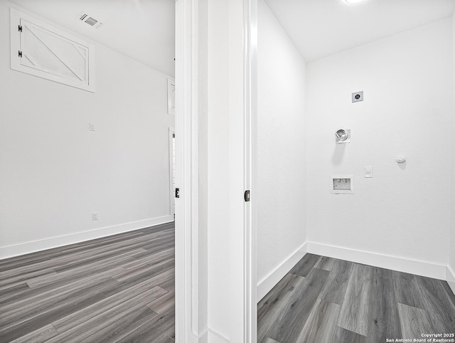 washroom with dark wood-style floors, hookup for an electric dryer, visible vents, and baseboards