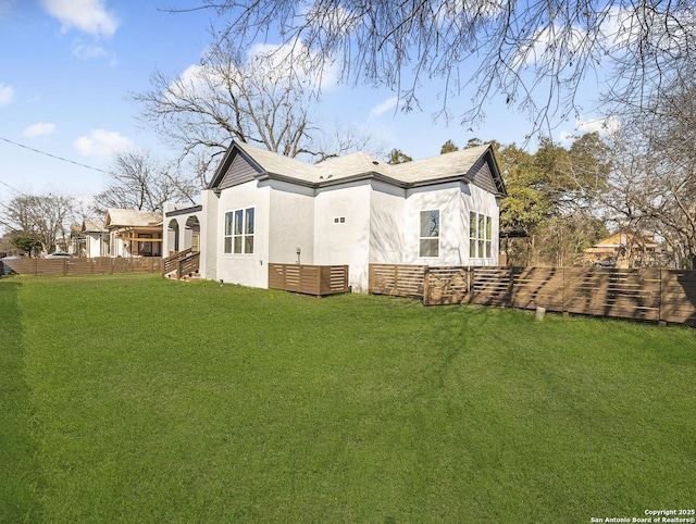 445 Cooper St, San Antonio, TX 78210 - view of side of home with a yard, fence, and stucco siding
