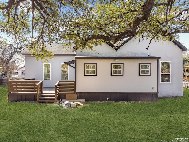 back of house featuring a deck and a yard