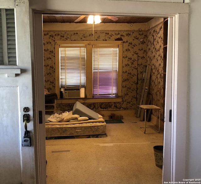 bedroom with wallpapered walls and cooling unit