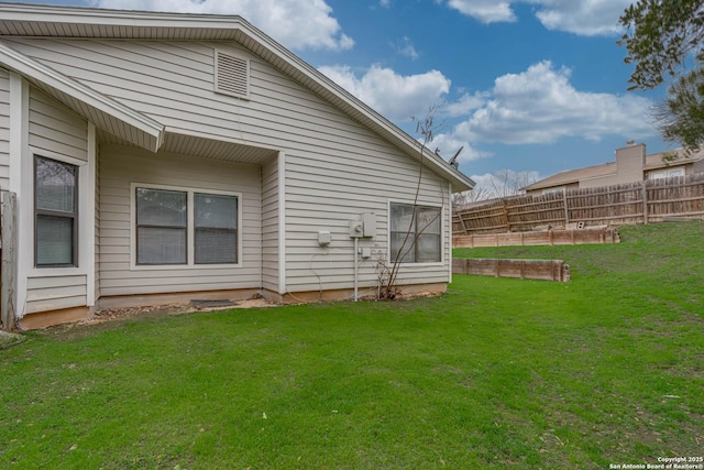 exterior space featuring a yard, fence, and a garden