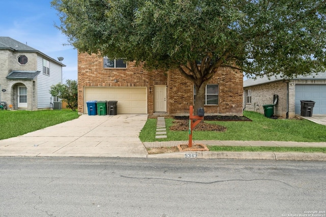 view of front of home with a front yard, concrete driveway, and brick siding