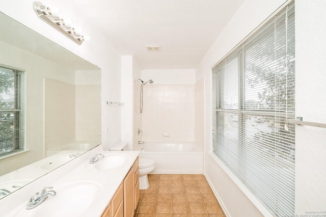 full bathroom with toilet, plenty of natural light, and a sink