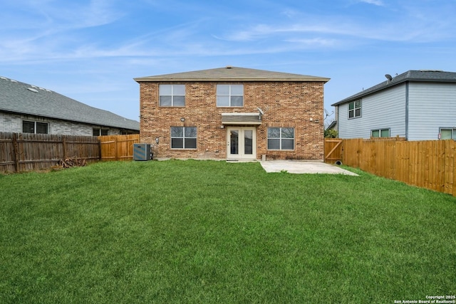 back of house featuring a patio, brick siding, and a lawn