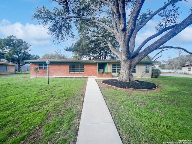 single story home with brick siding and a front lawn