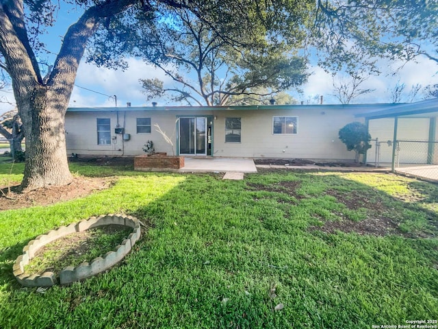 rear view of property with a lawn and fence