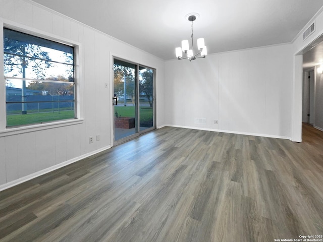 unfurnished room featuring crown molding, visible vents, a chandelier, and dark wood-style flooring