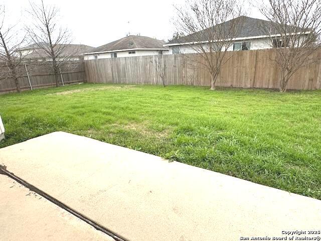 view of yard with a fenced backyard