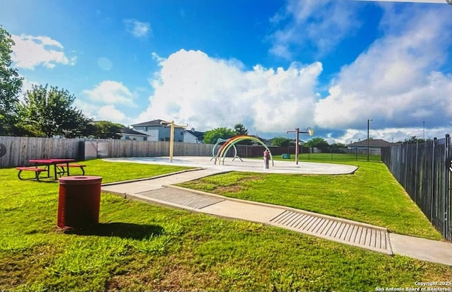 view of jungle gym with a lawn and fence