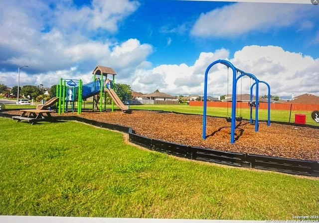 communal playground featuring a lawn