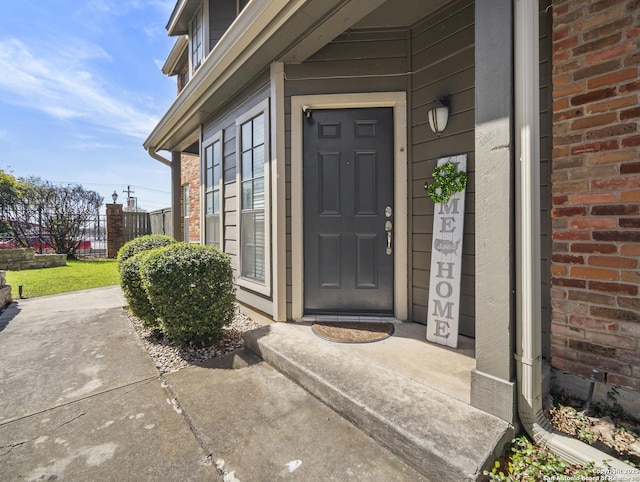 entrance to property featuring brick siding