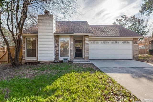 view of front of property with a garage, concrete driveway, a chimney, fence, and brick siding