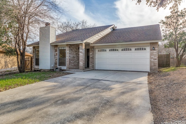 single story home with brick siding, a chimney, an attached garage, and fence