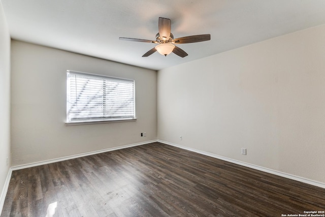 empty room featuring dark wood-style floors, ceiling fan, and baseboards