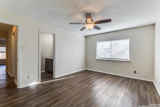 unfurnished bedroom with dark wood finished floors, a ceiling fan, and baseboards