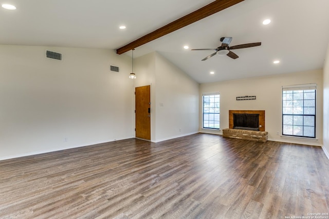 unfurnished living room with dark wood-type flooring, a brick fireplace, visible vents, and beamed ceiling