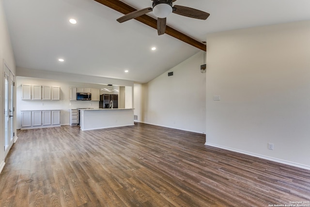 unfurnished living room featuring a ceiling fan, recessed lighting, lofted ceiling with beams, and wood finished floors