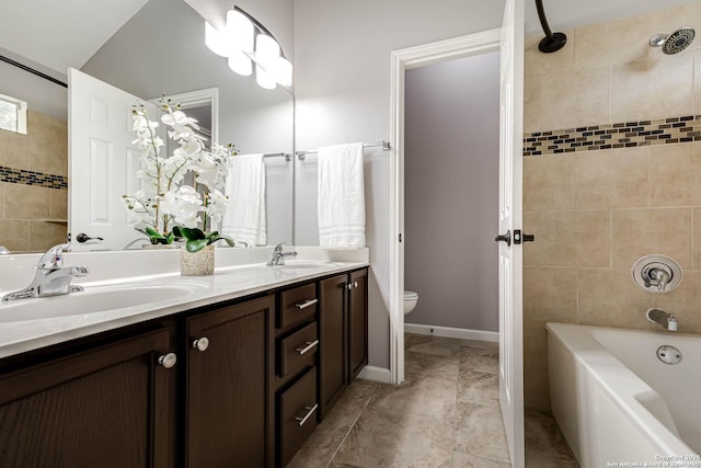 bathroom with double vanity, shower / bath combination, toilet, and a sink