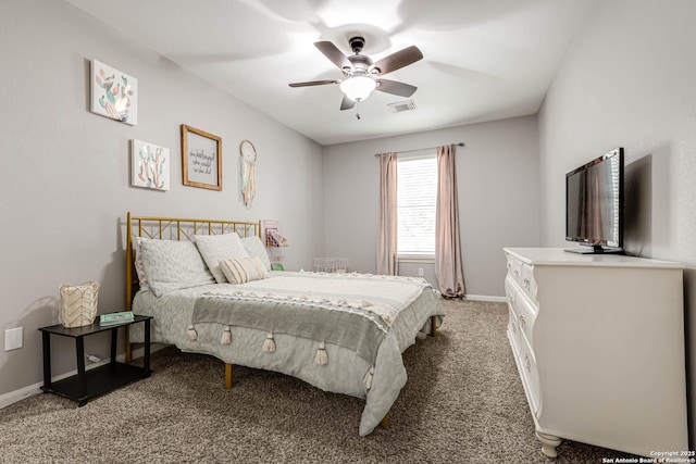 carpeted bedroom featuring a ceiling fan, visible vents, and baseboards