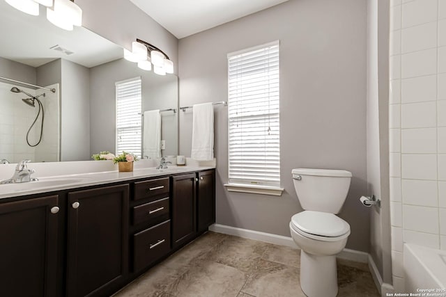 full bathroom featuring double vanity, plenty of natural light, visible vents, and a sink