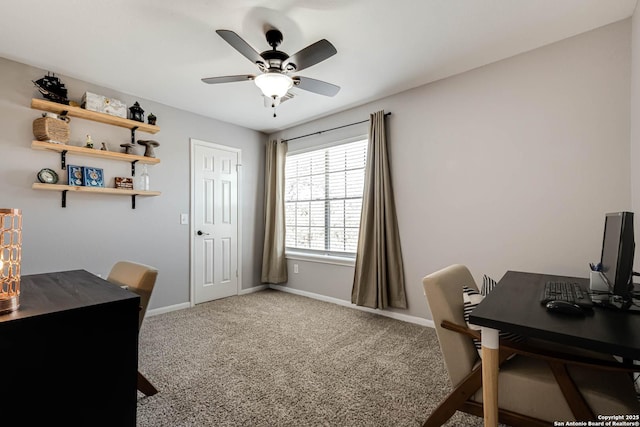 office space with a ceiling fan, baseboards, and carpet flooring