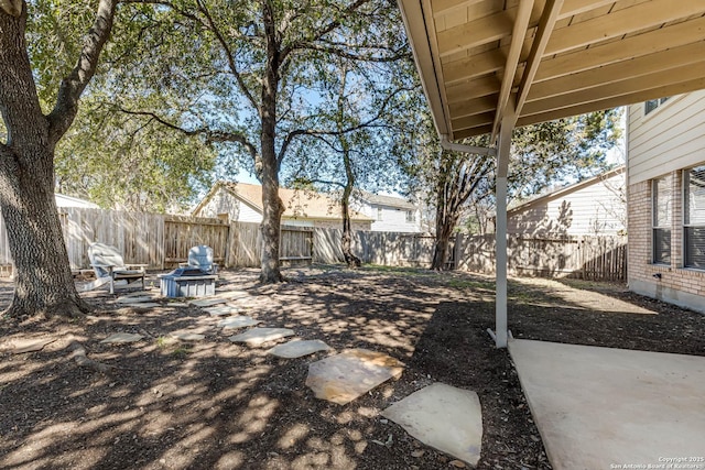 view of yard with a fenced backyard and a patio