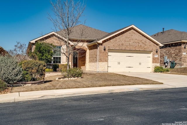 view of front facade featuring driveway, brick siding, an attached garage, and a shingled roof