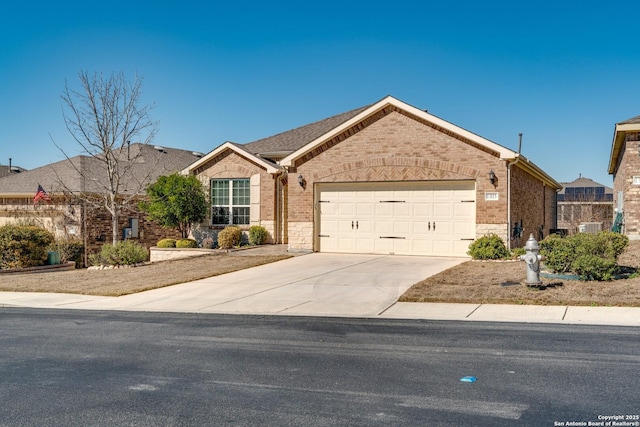 ranch-style house featuring an attached garage, concrete driveway, and brick siding