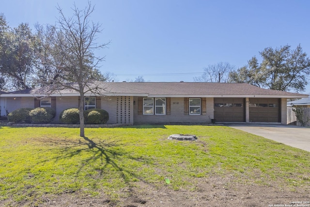 single story home with a garage, a front yard, and driveway